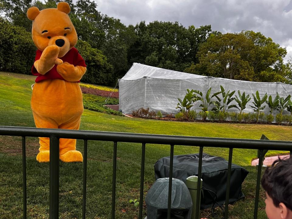 The author's children waving at Winnie the Pooh