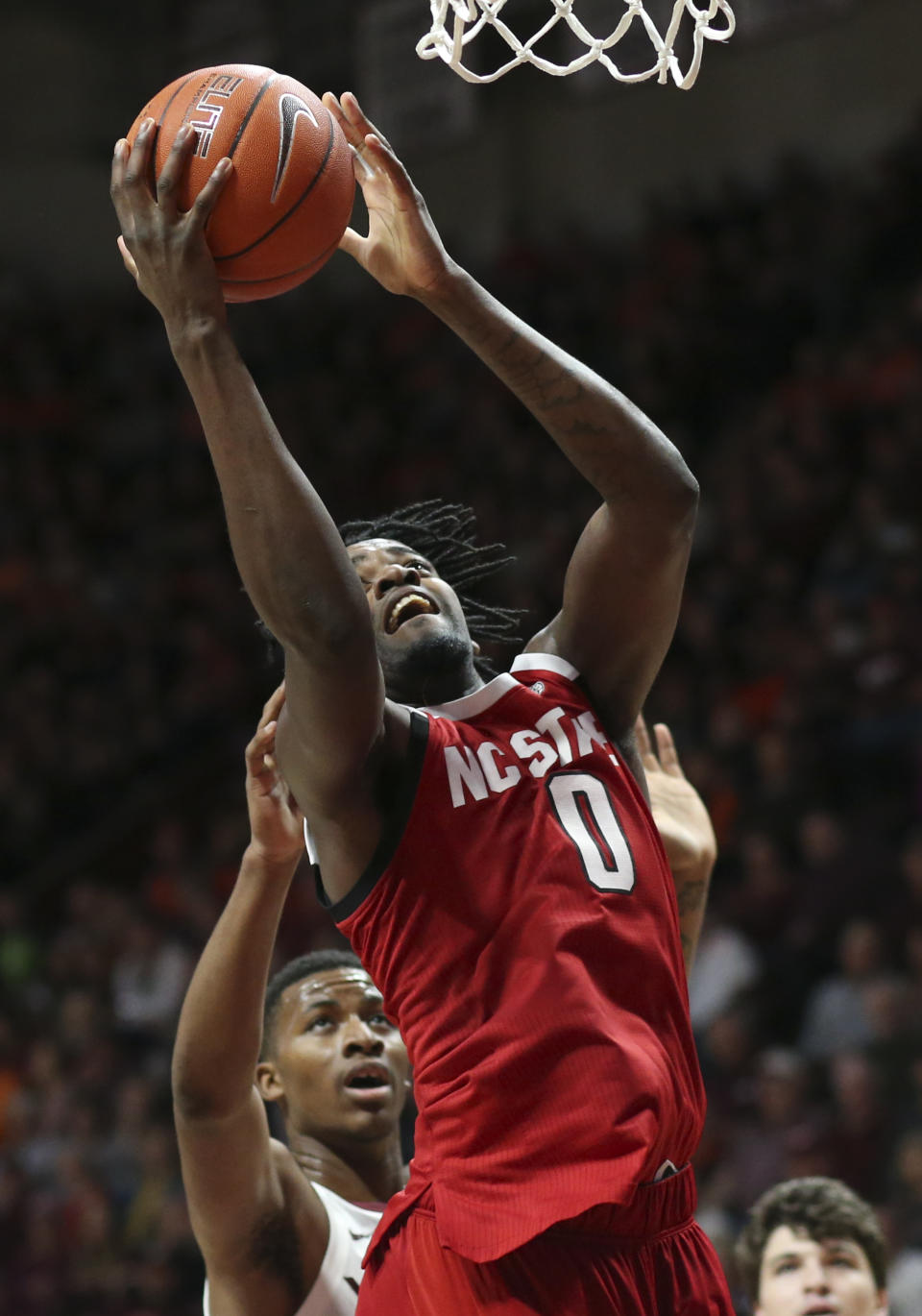 North Carolina State's D.J. Funderburk (0) scores past Virginia Tech's Landers Nolley II (2) in the first half of an NCAA college basketball game Saturday, Jan. 11, 2020, in Blacksburg, Va. (Matt Gentry/The Roanoke Times via AP)