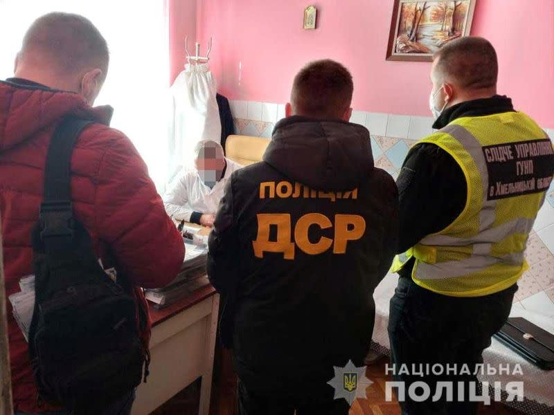 Police officers conduct a falsified COVID-19 vaccination certificates investigation the Khmelnytsky region