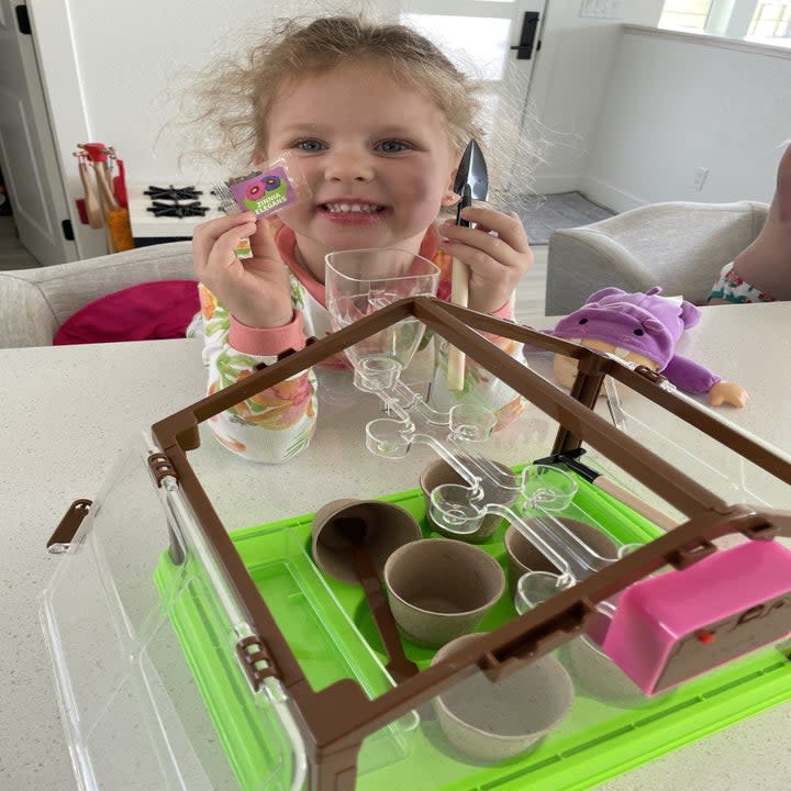 the author's daughter planting seeds