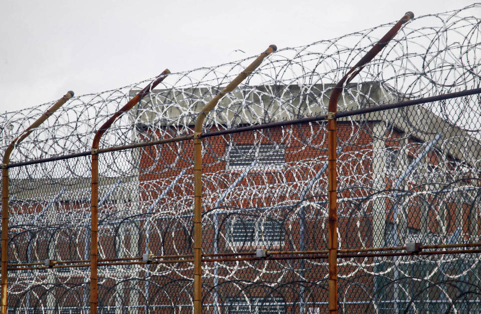 FILE - This March 16, 2011 file photo shows a barbed wire fence outside inmate housing on New York's Rikers Island correctional facility in New York. New York City’s notorious Rikers Island jail complex, troubled by years of neglect, has spiraled into turmoil during the coronavirus pandemic. (AP Photo/Bebeto Matthews, File)