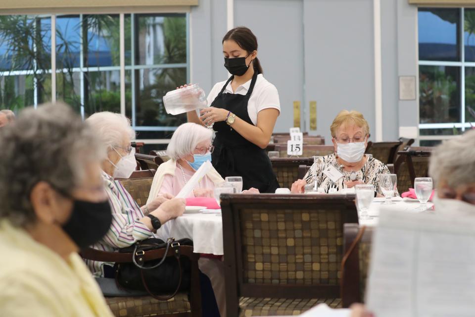 Alejandra Ferrera fills a water glass as residents fill the dining room for dinner service. She has worked at Aviva for almost two years in dining hospitality. The current labor market is leaving health care facilities understaffed and workers totally burnt out. Aviva Senior Living in Sarasota is having unprecedented hiring trouble. The facility has 10 full-time nursing positions open and getting hospitality staff has been such an issue that they’ve had to start serving independent living residents in their homes instead of in the communal dining room for social time.