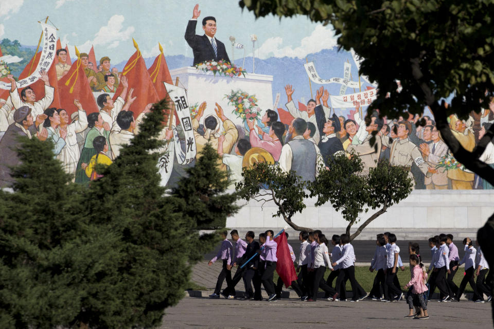 North Koreans youths march in a group past a mural as the capital prepares for the 70th anniversary of North Korea's founding day in Pyongyang, North Korea, Friday, Sept. 7, 2018. North Korea will be staging a major military parade, huge rallies and reviving its iconic mass games on Sunday to mark its 70th anniversary as a nation. (AP Photo/Ng Han Guan)