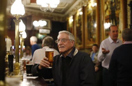 Retired widower Archibald Anderson drinks a pint of beer at the Cafe Royal in Edinburgh, Scotland May 1, 2014. REUTERS/Suzanne Plunkett