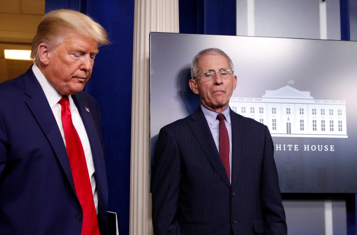 Donald Trump arrives for a White House briefing on the coronavirus pandemic as Anthony Fauci looks on: REUTERS