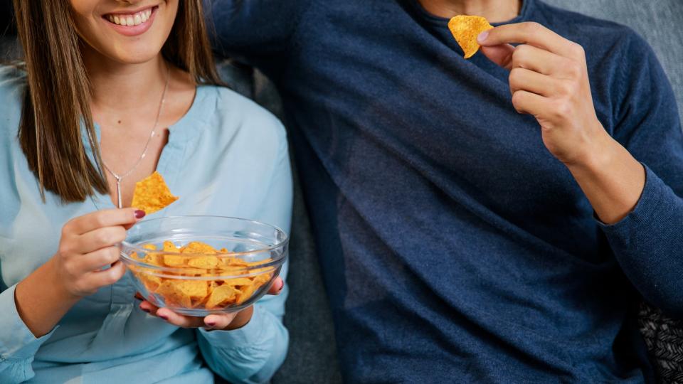 Couple eating tortilla chips