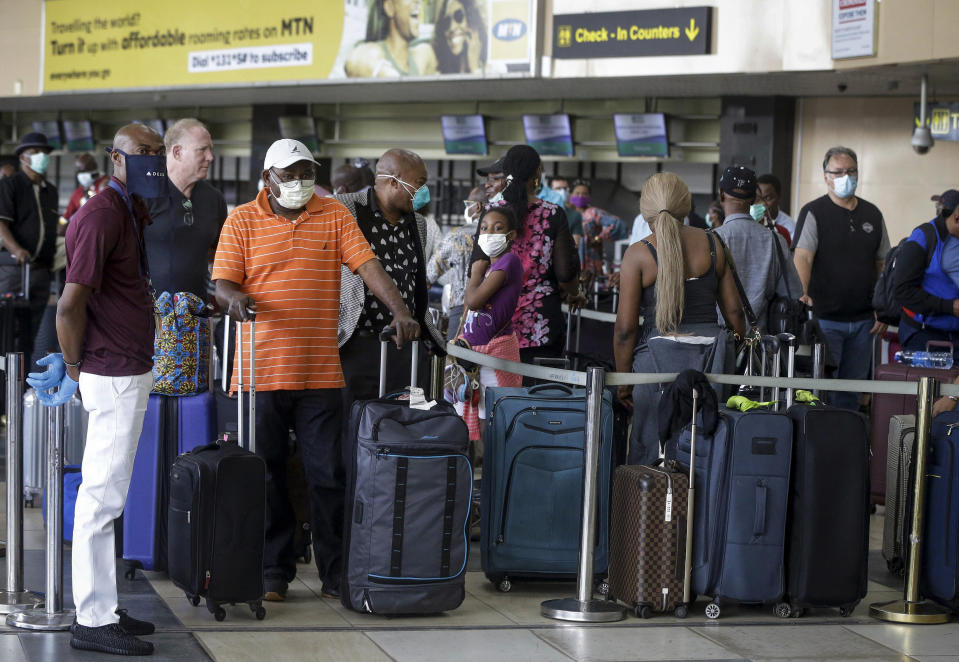 U.S. citizens queue to check in and be repatriated aboard an evacuation flight arranged by the U.S. embassy and chartered with Delta Air Lines, at the Murtala Mohammed International Airport in Lagos, Nigeria Tuesday, April 7, 2020. The new coronavirus causes mild or moderate symptoms for most people, but for some, especially older adults and people with existing health problems, it can cause more severe illness or death. (AP Photo/Sunday Alamba)