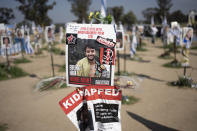 FILE - A poster depicting Israeli-American hostage Hersh Goldberg-Polin is displayed in Re'im, southern Israel at the Gaza border, Feb. 26, 2024, at a memorial site for the Nova music festival site where he was kidnapped to Gaza by Hamas on Oct. 7, 2023. Hamas on Wednesday, April 24, 2023, released a recorded video of an Israeli American still being held by the group. The video was the first sign of life of Hersh Goldberg-Polin since Hamas’ Oct. 7 attack on southern Israel. It was not clear when the video was taken. (AP Photo/Maya Alleruzzo, File)