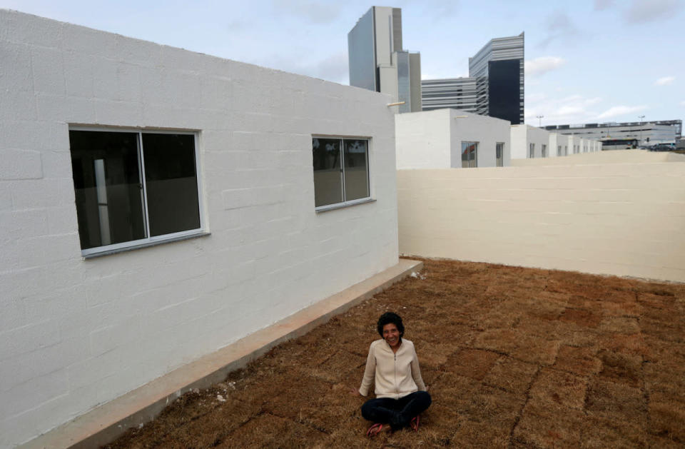 <p>Maria da Penha, 50, who has lived in Vila Autodromo slum for 23 years, poses outside her new house which is one of the twenty houses built for the residents who refused to leave the community, in Rio de Janeiro, Brazil, July 29, 2016. (REUTERS/Ricardo Moraes)</p>