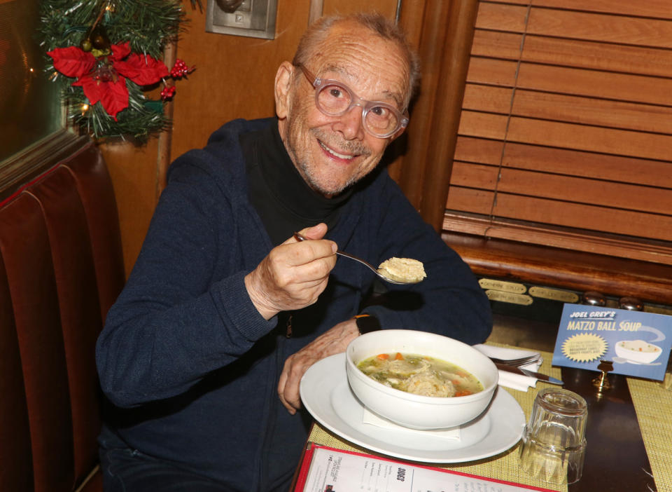 <p>Broadway legend Joel Grey gets cozy in N.Y.C. with Brooklyn Diner's famed matzo ball soup, now renamed in the actor's honor. For every bowl sold during the upcoming holiday season, a portion of profits will be donated to <a href="https://broadwaycares.org/" rel="nofollow noopener" target="_blank" data-ylk="slk:Broadway Cares;elm:context_link;itc:0;sec:content-canvas" class="link ">Broadway Cares</a>.</p>