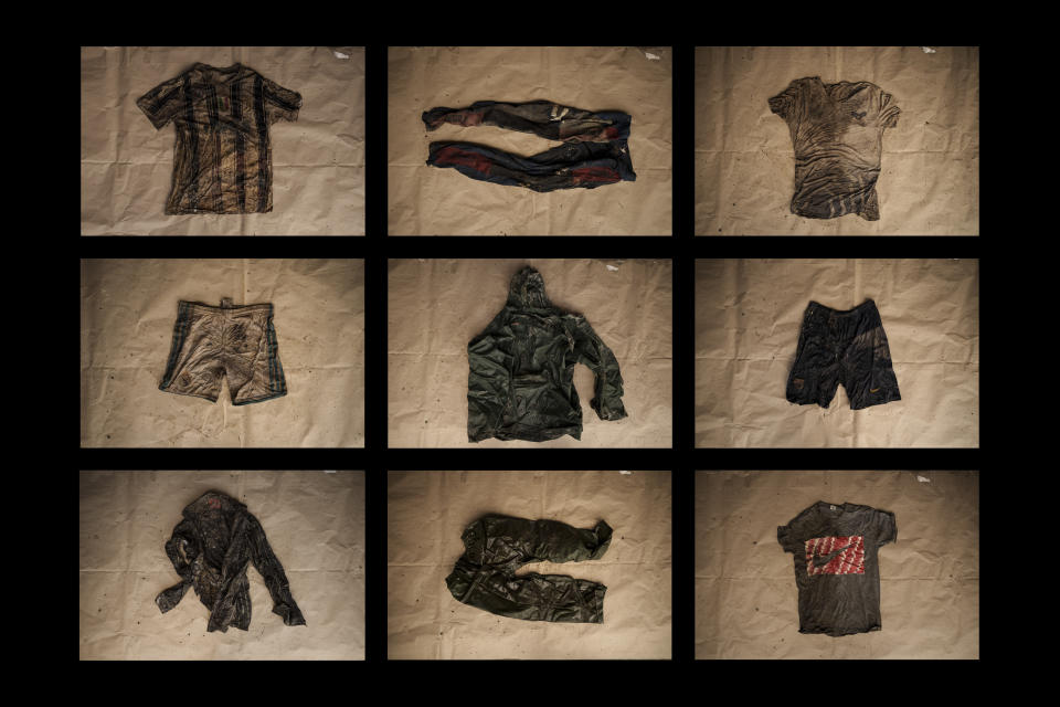 In this combination of photos, clothing found on deceased migrants whose remains were recovered from a Mauritanian boat on May 28, 2021, are laid out at the Scarborough police station on the island of Tobago, Trinidad and Tobago, Friday, Jan. 21, 2022. The boat was found by local fishermen drifting nearby on May 28, 2021 with 14 bodies and other skeletal remains inside. An AP investigation has found that the boat had departed the port town of Nouadhibou in Mauritania, Africa more than four months earlier with 43 migrants. (AP Photo/Felipe Dana)