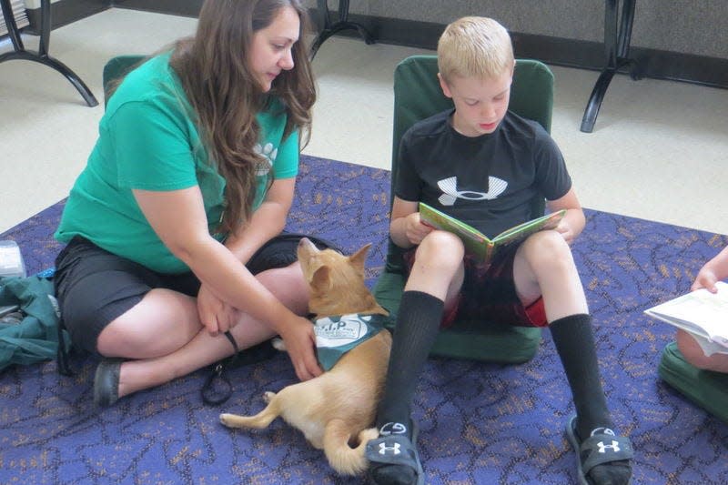 Registered therapy dogs listen to your child read aloud during the Read to a Dog program at the Monroe County Public Library.
