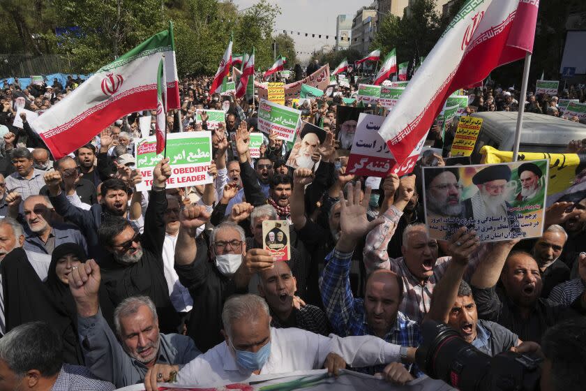 Iranian pro-government demonstrators attend a rally after their Friday prayers to condemn recent anti-government protests over the death of a young woman in police custody, in Tehran, Iran, Friday, Sept. 23, 2022. The crisis unfolding in Iran began as a public outpouring over the the death of Amini, a young woman from a northwestern Kurdish town who was arrested by the country's morality police in Tehran last week for allegedly violating its strictly-enforced dress code. (AP Photo/Vahid Salemi)