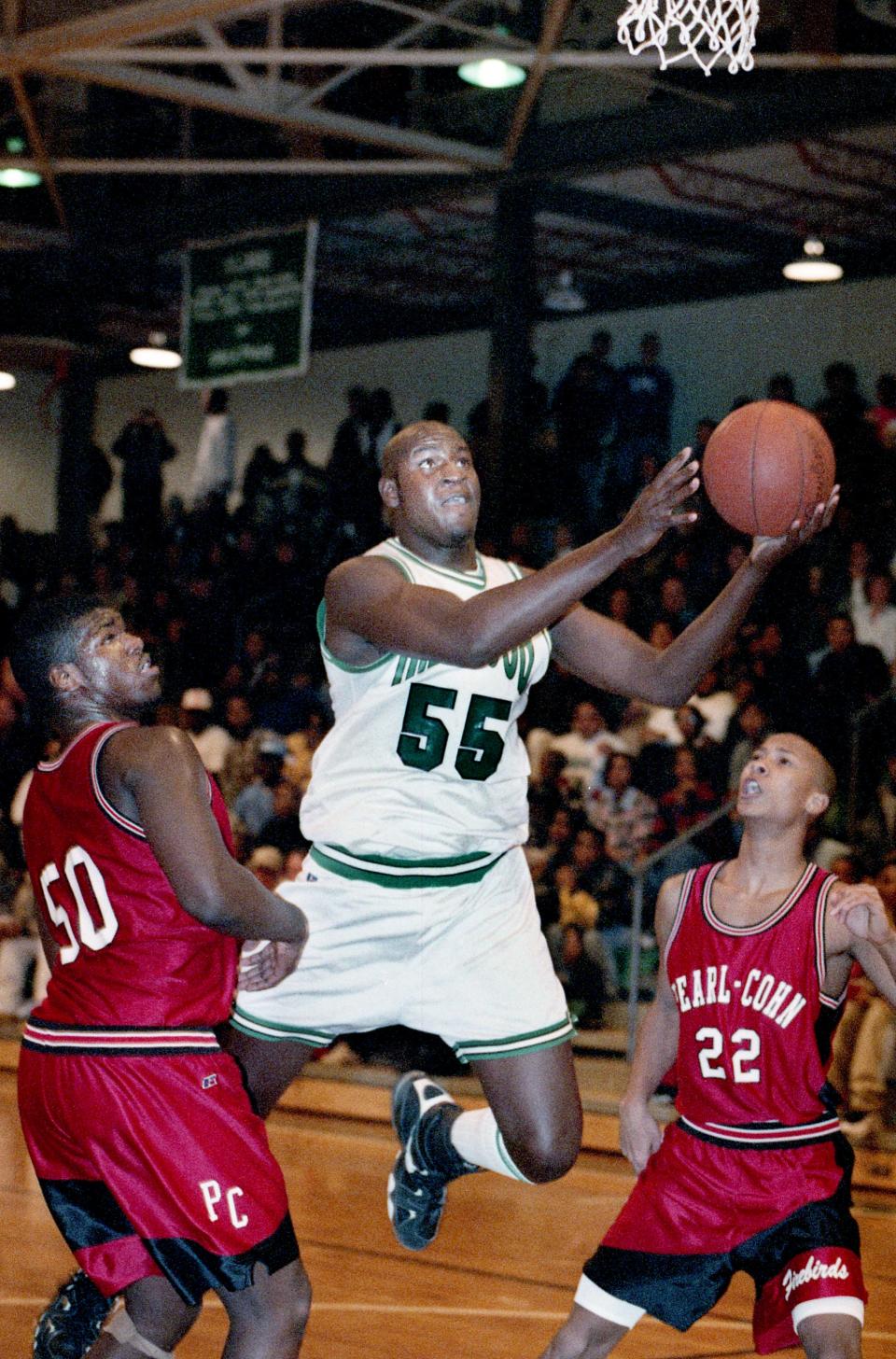 Hillwood High standout Charles Hathaway (55) splits Pearl-Cohn High defenders John Henderson, left, and Marshall Hyler for two of his 17 points, but Henderson had 10 points and Hyler 23 points and Pearl-Cohn won 70-60 Jan. 5, 1996.