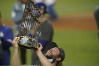 Los Angeles Dodgers pitcher Clayton Kershaw celebrates with the trophy after defeating the Tampa Bay Rays 3-1 to win the baseball World Series in Game 6 Tuesday, Oct. 27, 2020, in Arlington, Texas. (AP Photo/Eric Gay)