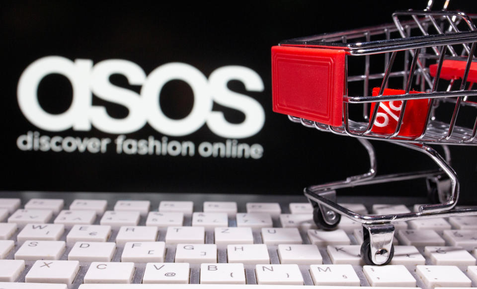 A keyboard and a shopping cart are seen in front of a displayed ASOS logo in this illustration picture taken October 13, 2020. REUTERS/Dado Ruvic/Illustration