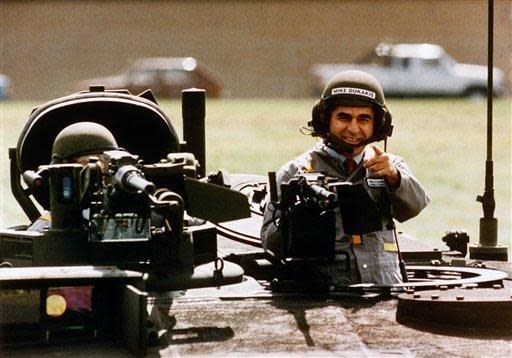 Democratic presidential candidate Michael Dukakis gets a ride in a new battle tank in 1988 in Sterling Heights, Mich.
