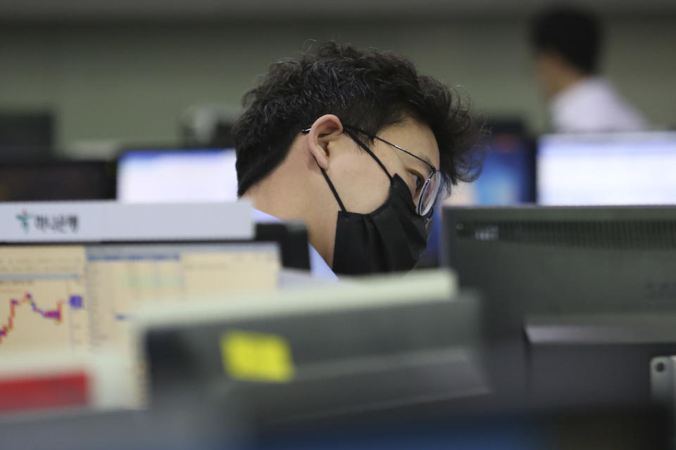 A currency trader watches monitor at the foreign exchange dealing room of the KEB Hana Bank headquarters in Seoul, South Korea, Wednesday, Feb. 26, 2020. Asian shares slid Wednesday following another sharp fall on Wall Street as fears spread that the growing virus outbreak will put the brakes on the global economy.(AP Photo/Ahn Young-joon)