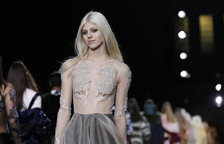 A model presents a creation from Topshop Unique Autumn/Winter 2014 collection during London Fashion Week February 16, 2014. REUTERS/Olivia Harris