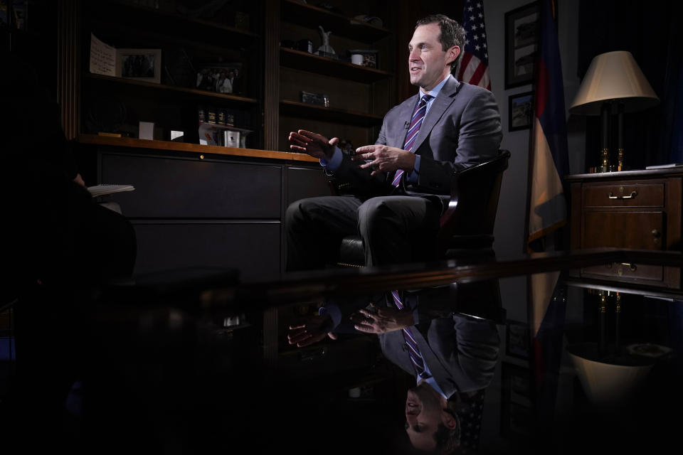 FILE - Rep. Jason Crow, D-Colo., talks during an interview with The Associated Press in his office on Capitol Hill in Washington, Dec. 15, 2021. Two decades ago, Crow was a 24-year-old platoon leader in the American invasion of Iraq. Platoon members carried gas masks and gear to wear over their uniforms to protect them from the chemical weapons the U.S. believed – wrongly – that Iraqi forces might use against them. Today, Crow sits on committees that oversee the U.S. military and intelligence agencies. (AP Photo/Susan Walsh, File)