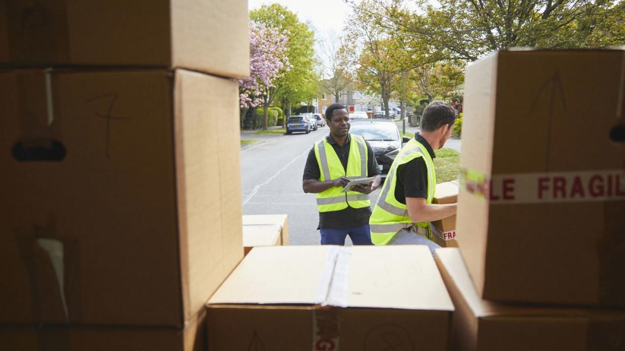 two removal men carrying boxes