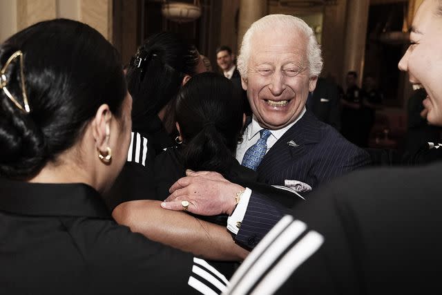 <p>Aaron Chown - WPA Pool/Getty</p> King Charles receives a group hug at Buckingham Palace on Sept 11, 2024