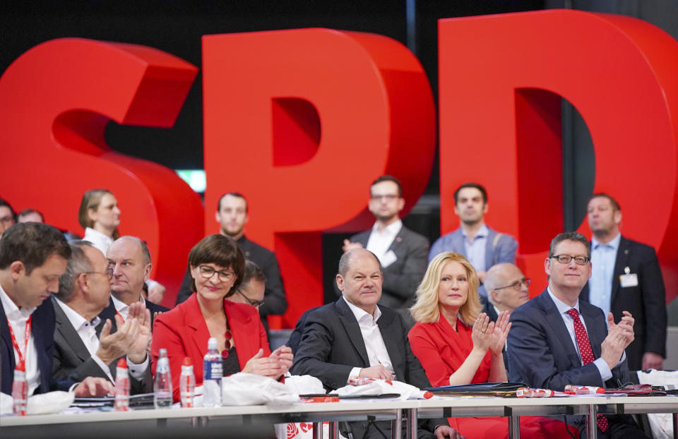 Party secretary Lars Klingbeil, Norbert Walter-Borjans, Saskia Esken, Federal Finance Minister Olaf Scholz, Manuela Schwesig and Thorsten Schaefer-Guembel, from left, during the German Social Democrats, SPD, federal party conference in Berlin, Germany, Friday, Dec. 6, 2019. Members of the center-left party have choosen the left-leaning duo Norbert Walter-Borjans and Saskia Esken as their new leaders. This has to be confirmed by the delegates at the party meeting. (Kay Nietfeld/dpa via AP)