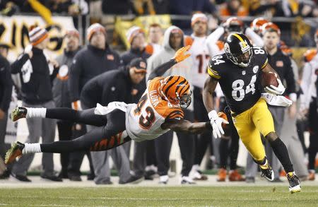 Dec 28, 2014; Pittsburgh, PA, USA; Pittsburgh Steelers wide receiver Antonio Brown (84) runs past Cincinnati Bengals strong safety George Iloka (43) to score a sixty-three yard touchdown during the fourth quarter at Heinz Field. Charles LeClaire-USA TODAY Sports