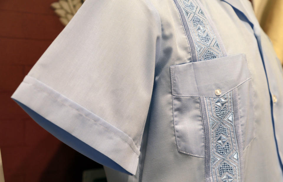 In this Wednesday, Oct. 17, 2012 photo, a guayabera made in Mexico in 2012 featuring machine made embroidery, is on display at an exhibition titled "The Guayabera: A Shirt's Story" at the Museum of History Miami, in Miami. This is the first exhibition to trace the story of the shirt's evolution through Cuba, Mexico, and the United States. (AP Photo/Lynne Sladky)