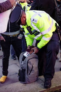 <span class="caption">Police search an unknown protester during a Stop The War Coalition protest, March 7 2018.</span> <span class="attribution"><a class="link " href="https://www.shutterstock.com/image-photo/london-united-kingdom-07th-march-2018-1041949144?src=gq--0iFNt6ZYwoy0gNi65A-1-0&studio=1" rel="nofollow noopener" target="_blank" data-ylk="slk:Ben Gingell/Shutterstock.com;elm:context_link;itc:0;sec:content-canvas">Ben Gingell/Shutterstock.com</a></span>