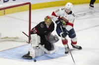 Florida Panthers center Anton Lundell tries to get his stick on the puck following a save by Ottawa Senators goaltender Joonas Korpisalo during the second period of an NHL hockey game Thursday, April 4, 2024, in Ottawa, Ontario. (Adrian Wyld/The Canadian Press via AP)