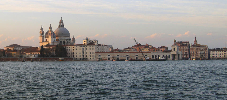 FILE - This Nov. 9, 2013 file photo shows the Basilica di Santa Maria della Salute (St. Mary of Health) at sunset as seen from the water to the south. The church, built after plague broke out in the 17th century, is a fixture of the city's skyline. The Venice Film Festival, a top launching pad for awards hopefuls, announces the lineup for the 80th edition, which could now be stripped of some of its Hollywood glamour because of the ongoing actors and writers strike. (AP Photo/Michelle Locke)