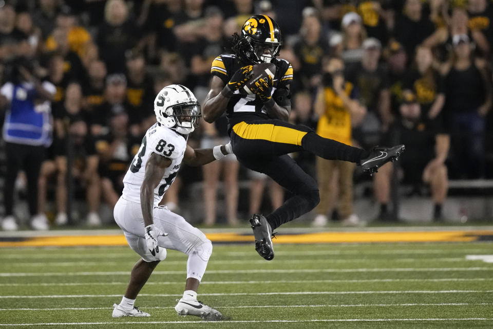 Iowa defensive back Jermari Harris (27) intercepts a pass intended for Michigan State wide receiver Montorie Foster Jr. (83) during the second half of an NCAA college football game, Saturday, Sept. 30, 2023, in Iowa City, Iowa. Iowa won 26-16. (AP Photo/Charlie Neibergall)