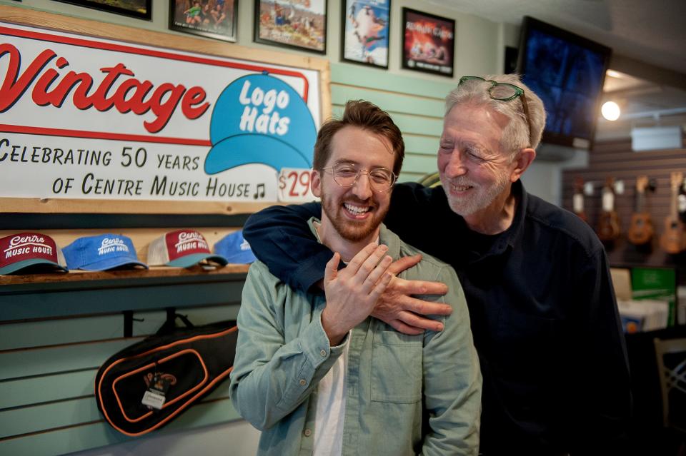 Corbit Larson, owner of Centre Music House in Framingham, shares a light moment with his son, Max, at the store, Oct. 13, 2023.
