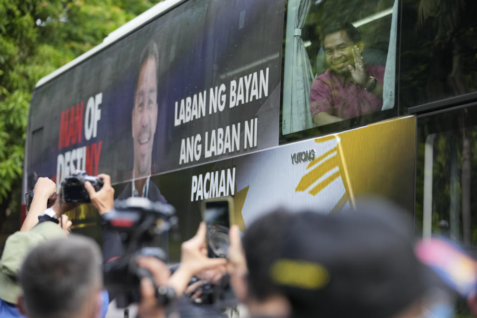 Retired Filipino boxing hero and senator Manny Pacquiao waves from his vehicle before filing his certificate of candidacy for next year's presidential elections at the Commission on Elections on Friday, Oct. 1, 2021 in Manila, Philippines. Friday marks the start of a weeklong registration period for candidates seeking to lead a Southeast Asian nation that has been hit hard by the pandemic and deep political conflicts.(AP Photo/Aaron Favila)