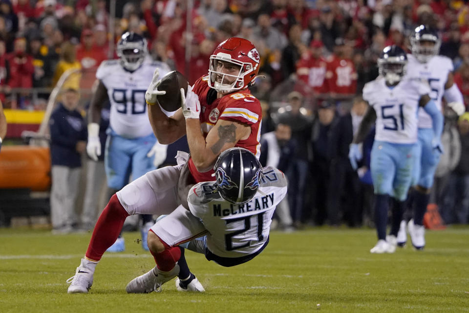 Kansas City Chiefs tight end Noah Gray (83) catches a pass as Tennessee Titans cornerback Roger McCreary (21) defends during overtime of an NFL football game Sunday, Nov. 6, 2022, in Kansas City, Mo. The Chiefs won 20-17. (AP Photo/Ed Zurga)