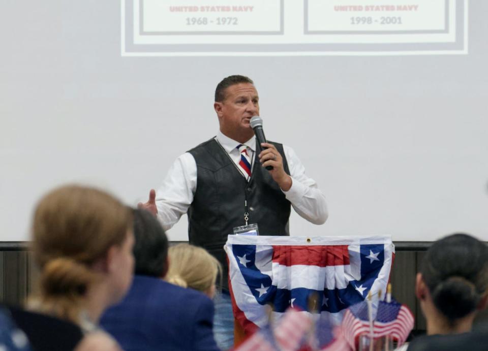 Lucerne Valley Unified School District Assistant Superintendent Nate Lambdin addresses the audience during a ceremony where the district recognized a group of its employees who served in the U.S. military.