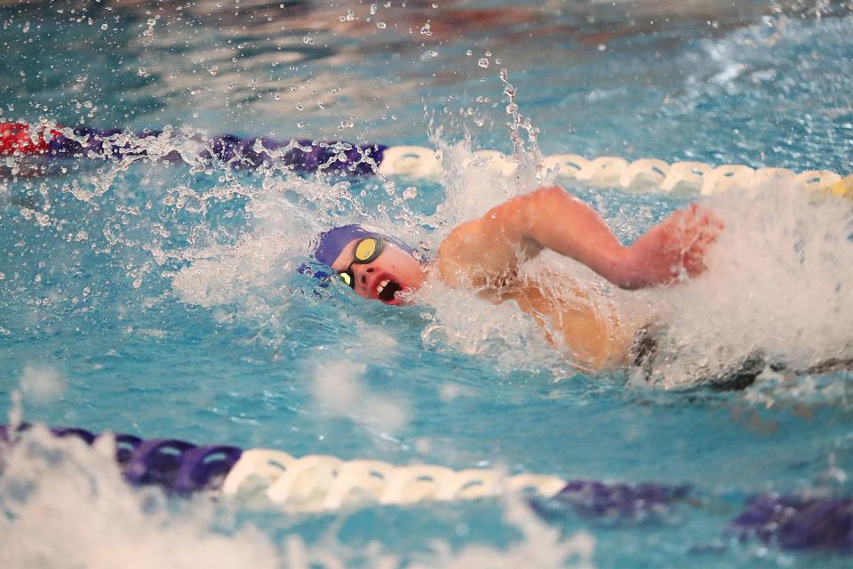 McNary's Caleb Skipper competes in the 50-yard freestyle race during the 6A-6 District swim meet at Juniper Swim & Fitness in Bend on Saturday, Feb. 12, 2022. 