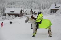 Police on horses monitors the Corona conditions at Torfhaus, Germany, Sunday, Jan. 17, 2021. (Matthias Bein/dpa via AP)