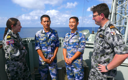 Royal Australian Navy sailors stand with officers from the Chinese Navy aboard the Royal Australian Navy frigate HMAS Newcastle during Australia's largest maritime exercise 'Exercise Kakadu' being conducted off the coast of Darwin in northern Australia, September 8, 2018. Picture taken September 8, 2018. REUTERS/Jill Gralow
