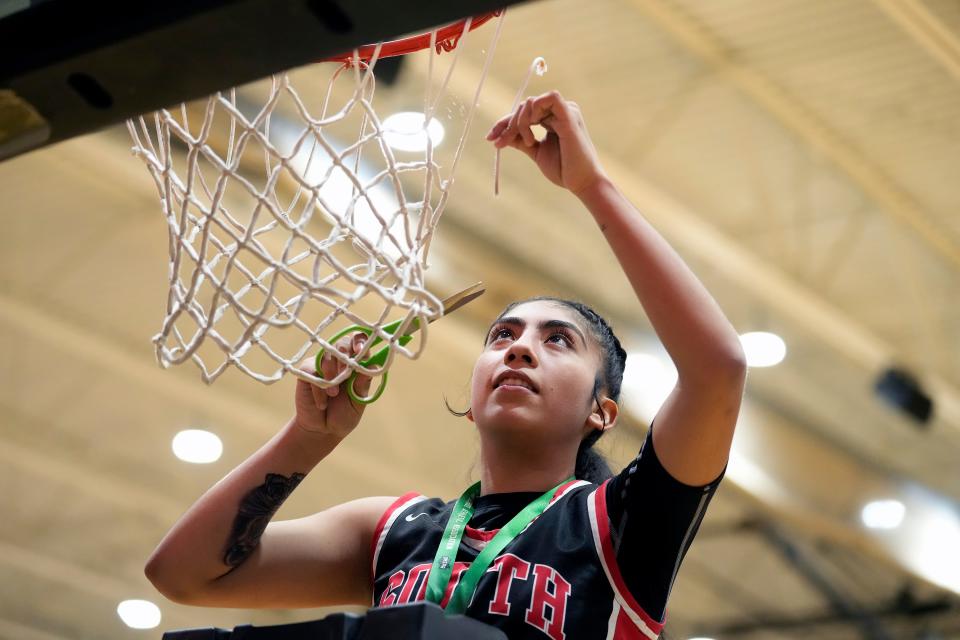 Westerville South's Tamara Ortiz cuts off a piece of the net during the district championship celebration Saturday at Ohio Dominican. The Wildcats beat Olentangy Liberty 50-40.