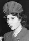 FILE - Princess Elizabeth wears a new style of hat during a visit to the Yugo-Slav exhibition at Burlington House on Jan. 31, 1944 in London. Her new choice of hat has distinct military lines -- a small peak and high pleated crown. (AP Photo, File)