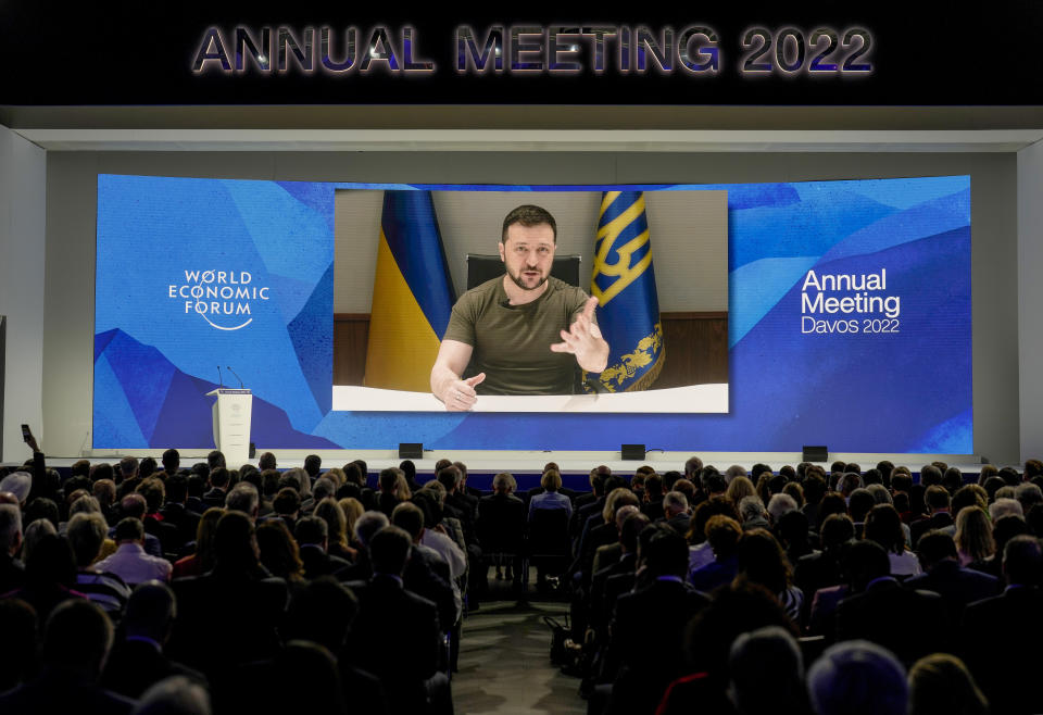 Ukrainian President Volodymyr Zelenskyy displayed on a screen as he addresses the audience from Kyiv on a screen during the World Economic Forum in Davos, Switzerland, Monday, May 23, 2022. The annual meeting of the World Economic Forum is taking place in Davos from May 22 until May 26, 2022. (AP Photo/Markus Schreiber)