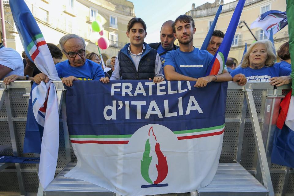 Brothers of Italy’s emblem contains the flame symbol of the neofascist Italian Social Movement. <a href="https://www.gettyimages.com/detail/news-photo/supporters-with-a-brothers-of-italy-flag-during-the-news-photo/1243340253?adppopup=true" rel="nofollow noopener" target="_blank" data-ylk="slk:Marco Cantile/LightRocket via Getty Images;elm:context_link;itc:0;sec:content-canvas" class="link ">Marco Cantile/LightRocket via Getty Images</a>