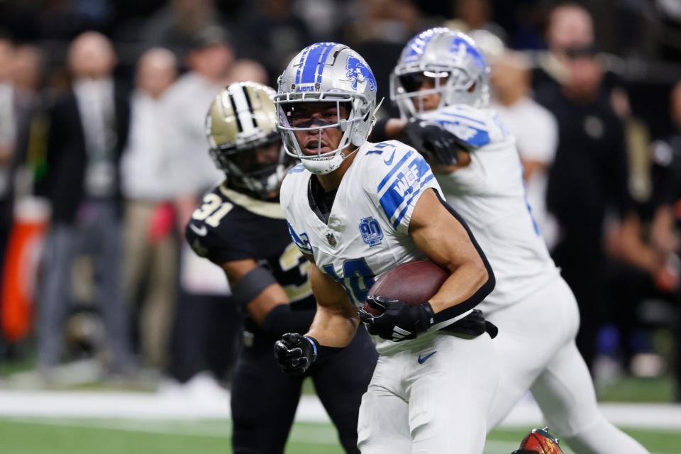 Lions wide receiver Amon-Ra St. Brown rushes for a touchdown during the first half on Sunday, Dec. 3, 2023, in New Orleans.