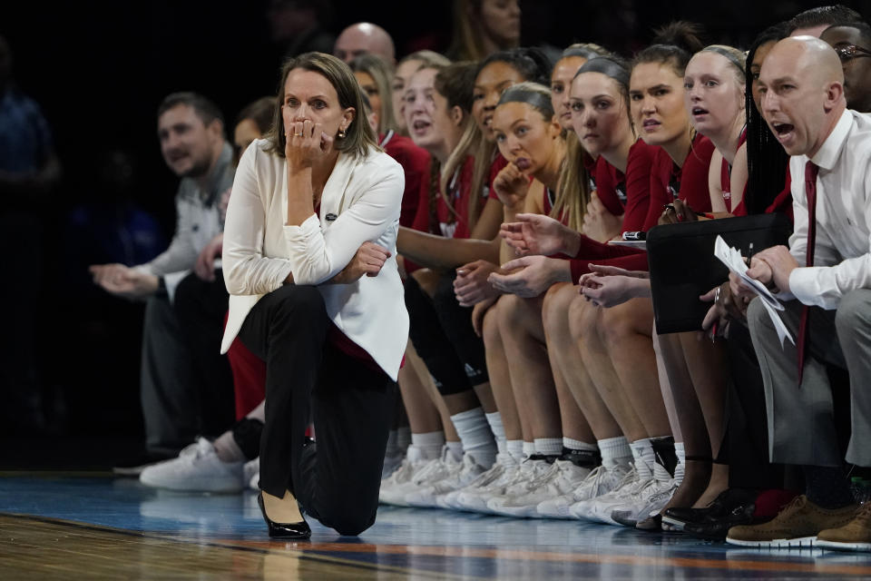 South Dakota head coach Dawn Plitzuweit is seen on the sidelines during the first half of a college basketball game against Michigan in the Sweet 16 round of the NCAA women's tournament Saturday, March 26, 2022, in Wichita, Kan. (AP Photo/Jeff Roberson)