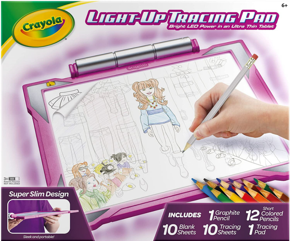 Product image of the Crayola Light-Up Tracing Pad in pink with a caucasian hand holding the pencil over the paper drawing a girl.