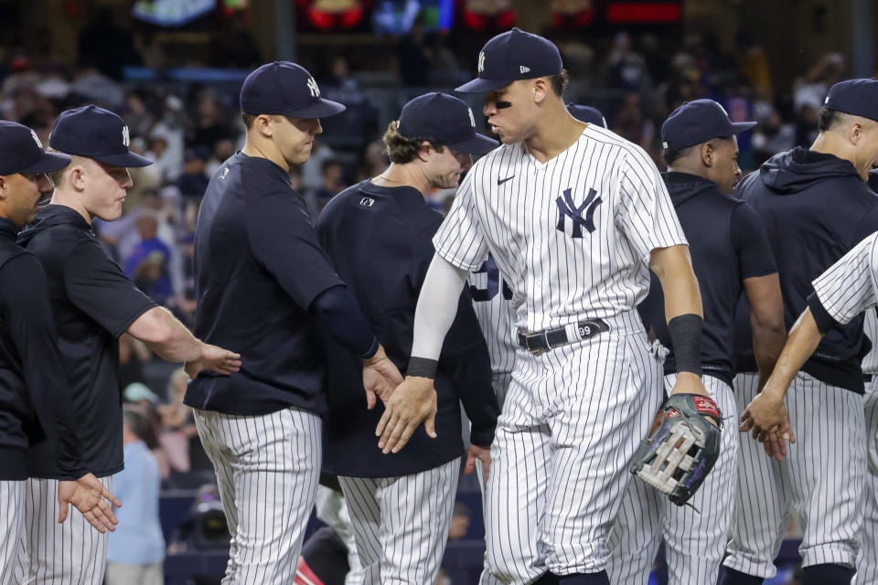 New York Yankees' Aaron Judge celebrates a win with teammate after a baseball game against the New York Mets, Monday, Aug. 22, 2022, in New York. (AP Photo/Corey Sipkin)