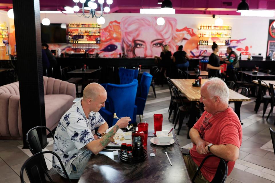 Alec Byres, left, and his father, David Byers, enjoy breakfast at newly opened Tulua Bistro, at 1703 N. Main St. in historic Springfield. A mural of pop star Lady Gaga adorns the wall behind the restaurant's bar.