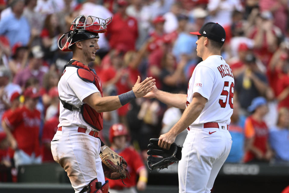 St. Louis Cardinals catcher Andrew Knizner, left, and St. Louis Cardinals relief pitcher Ryan Helsley (56), right, celebrate their team's 6-5 victory after a baseball game against the Philadelphia Phillies, Sunday, Sept. 17, 2023, in St. Louis. (AP Photo/Joe Puetz)